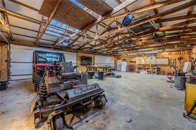 garage featuring a garage door opener and freestanding refrigerator