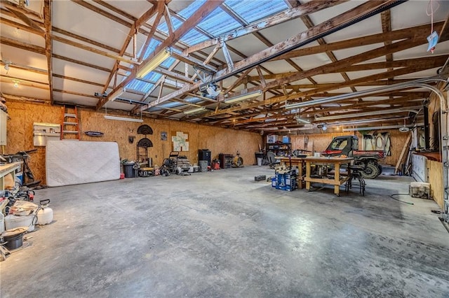 garage with a workshop area and a garage door opener