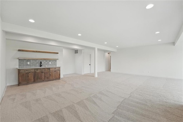 1518 NW 106th Ter, Kansas City, MO 64155 - unfurnished living room with recessed lighting, light carpet, and bar area