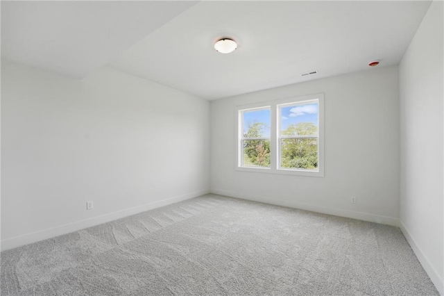 1518 NW 106th Ter, Kansas City, MO 64155 - spare room with baseboards and light carpet