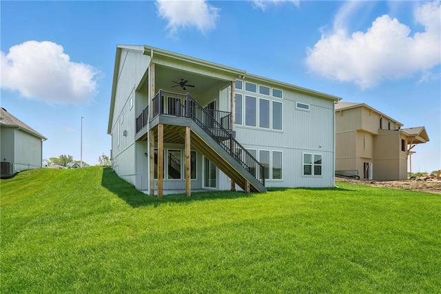 1518 NW 106th Ter, Kansas City, MO 64155 - rear view of house with ceiling fan, stairs, a lawn, and a wooden deck