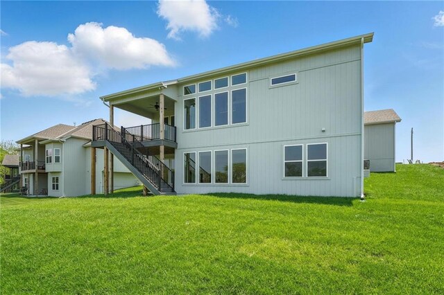 1518 NW 106th Ter, Kansas City, MO 64155 - rear view of property with ceiling fan, stairway, a yard, and a wooden deck