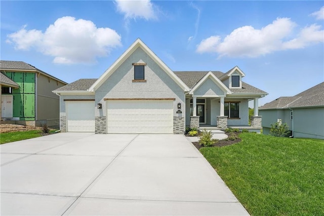 1518 NW 106th Ter, Kansas City, MO 64155 - view of front of house featuring covered porch, a front yard, an attached garage, concrete driveway, and stone siding