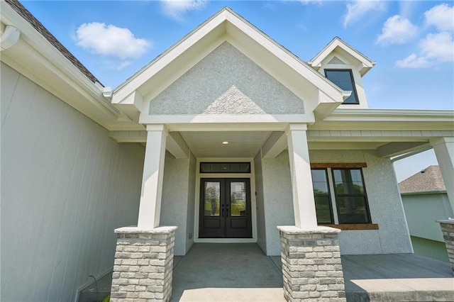 1518 NW 106th Ter, Kansas City, MO 64155 - entrance to property featuring french doors, stucco siding, and a porch
