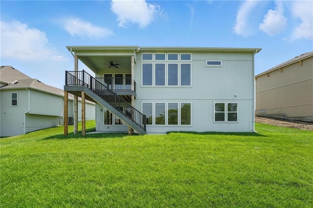 1518 NW 106th Ter, Kansas City, MO 64155 - back of property with a ceiling fan, stairway, a lawn, and a wooden deck