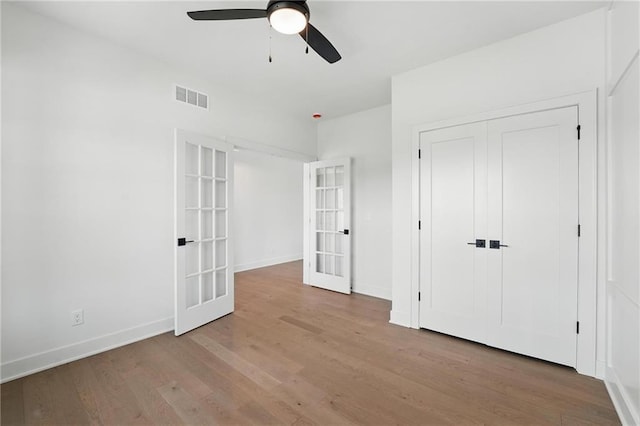 1518 NW 106th Ter, Kansas City, MO 64155 - unfurnished bedroom with french doors, wood finished floors, ceiling fan, and a closet