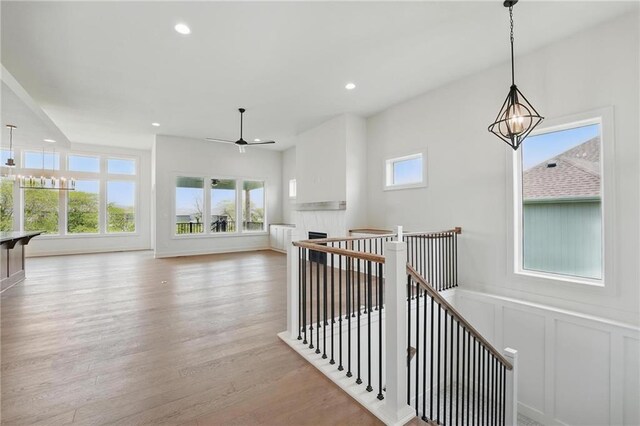 1518 NW 106th Ter, Kansas City, MO 64155 - hallway with a decorative wall, wood finished floors, recessed lighting, an upstairs landing, and a wainscoted wall