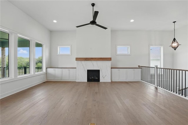 1518 NW 106th Ter, Kansas City, MO 64155 - unfurnished living room with ceiling fan, light wood-style floors, a high end fireplace, and recessed lighting
