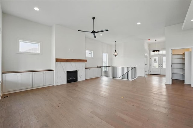 1518 NW 106th Ter, Kansas City, MO 64155 - unfurnished living room featuring light wood finished floors, a ceiling fan, recessed lighting, and a high end fireplace