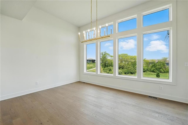 1518 NW 106th Ter, Kansas City, MO 64155 - unfurnished dining area with wood-type flooring and a chandelier