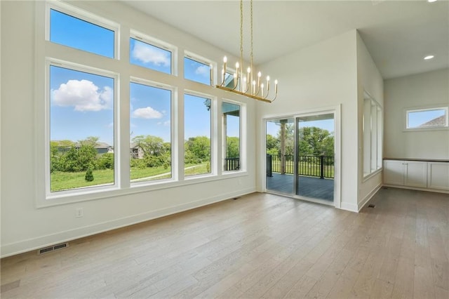 1518 NW 106th Ter, Kansas City, MO 64155 - unfurnished dining area featuring a chandelier, hardwood / wood-style flooring, healthy amount of natural light, and recessed lighting