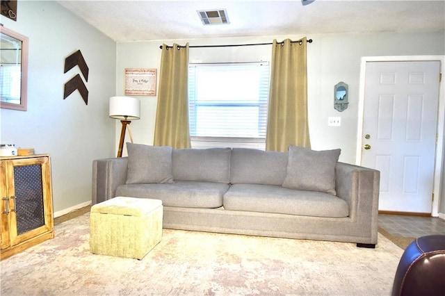 living area with visible vents and baseboards