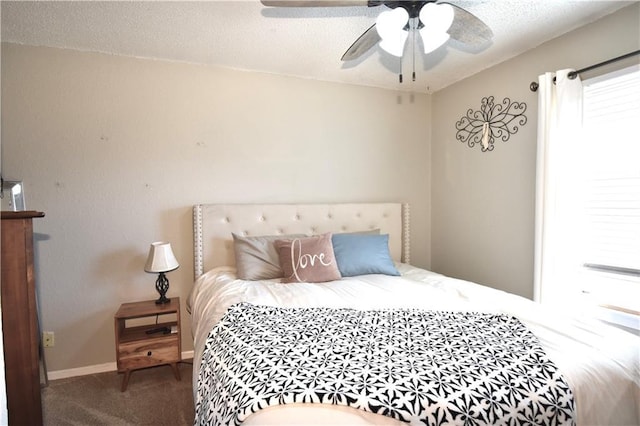 bedroom featuring a ceiling fan, carpet, baseboards, and a textured ceiling