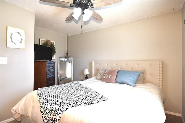 carpeted bedroom with baseboards, a textured ceiling, and ceiling fan