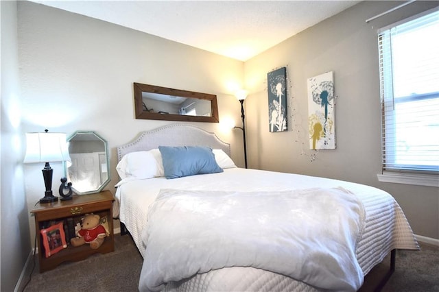 carpeted bedroom featuring baseboards