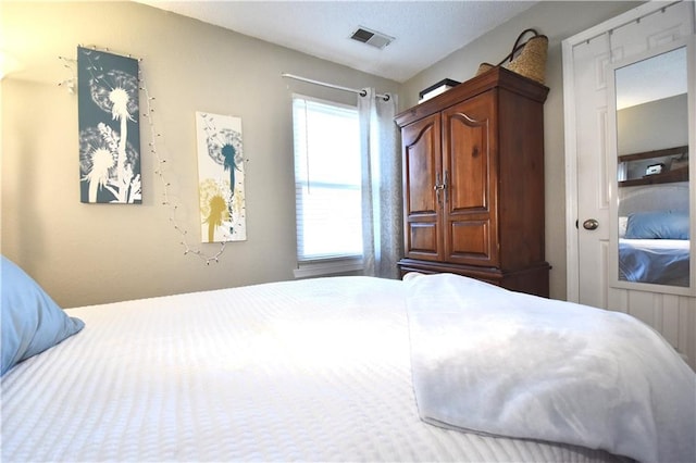 bedroom featuring visible vents