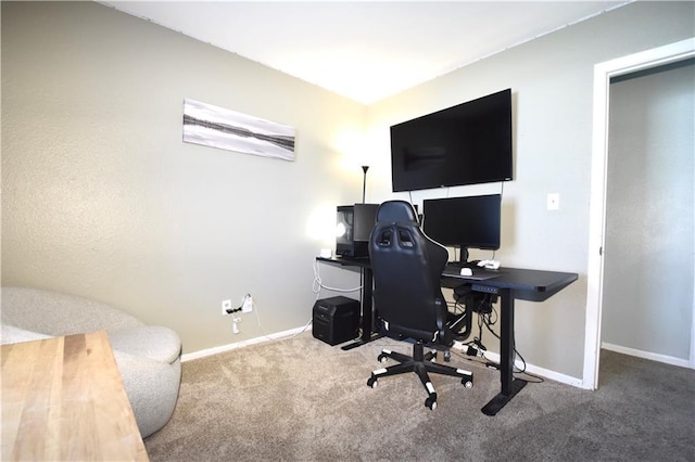 carpeted home office with baseboards