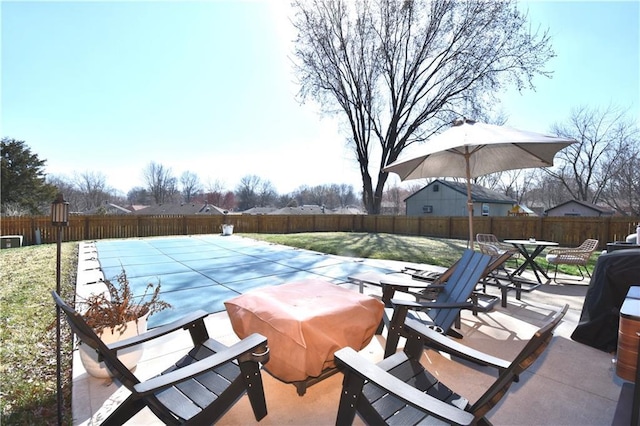 view of pool featuring a fenced in pool, a lawn, outdoor dining area, a fenced backyard, and a patio area