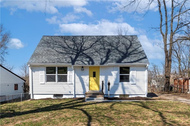 cape cod home with a front yard and fence