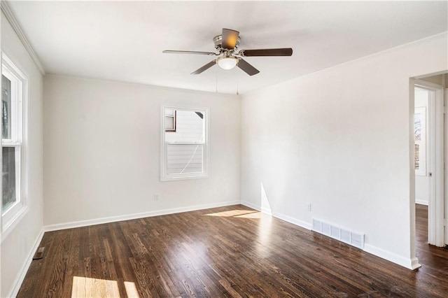 empty room with a ceiling fan, wood finished floors, visible vents, and baseboards