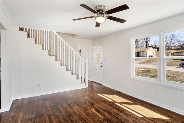 interior space with baseboards, stairs, dark wood-type flooring, and a ceiling fan