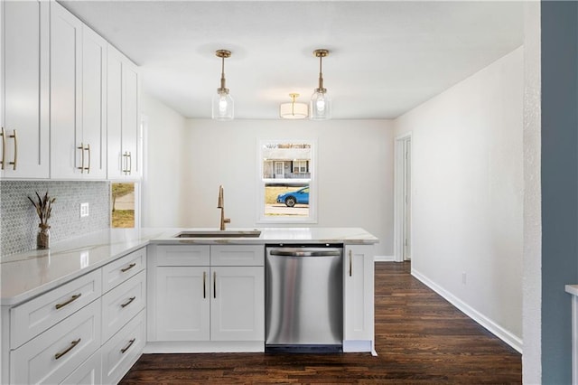 kitchen with a peninsula, a sink, decorative backsplash, light countertops, and stainless steel dishwasher