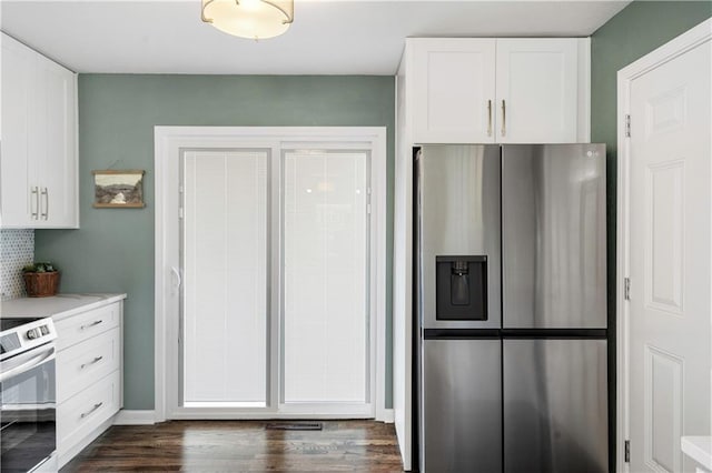 kitchen featuring dark wood finished floors, appliances with stainless steel finishes, white cabinetry, and light countertops