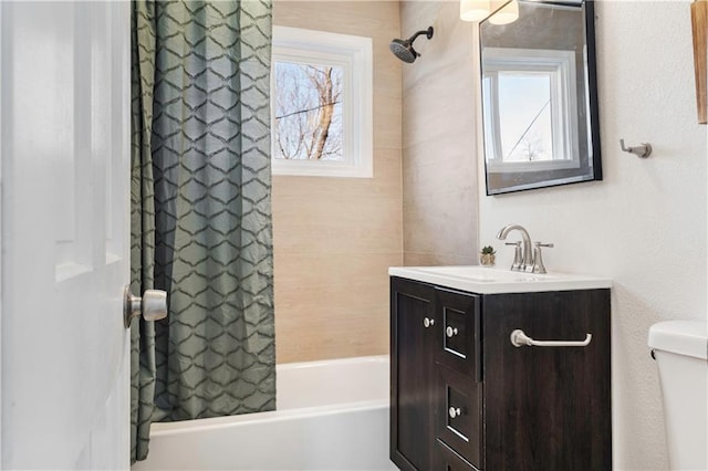 full bathroom featuring toilet, vanity, and shower / tub combo with curtain