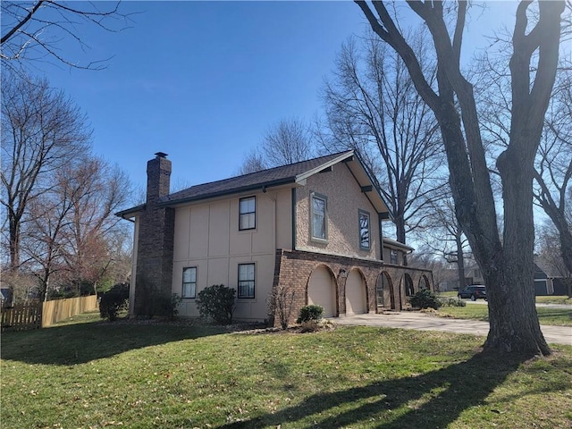 view of side of home featuring brick siding, fence, concrete driveway, a chimney, and an attached garage