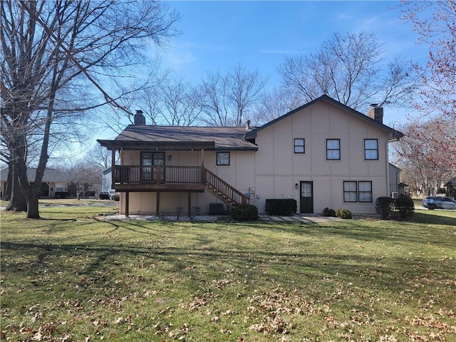 rear view of house with stairs, a yard, board and batten siding, and a chimney