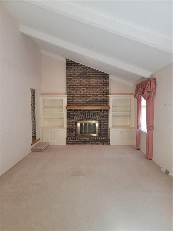 unfurnished living room with lofted ceiling with beams, light colored carpet, and a fireplace