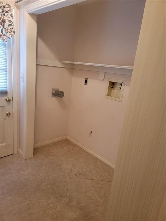 clothes washing area featuring electric dryer hookup, washer hookup, laundry area, and light tile patterned floors