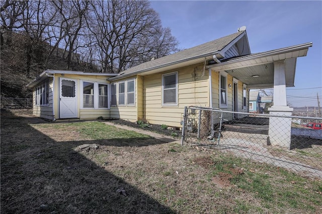 exterior space with an attached carport and fence