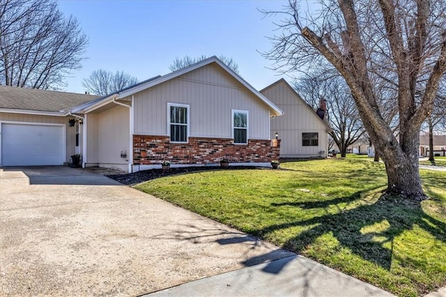view of front of property with a front yard, brick siding, a garage, and driveway