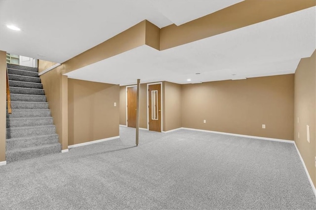 finished basement featuring stairway, recessed lighting, carpet, and baseboards
