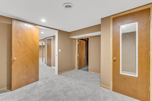spare room featuring visible vents, recessed lighting, carpet, and baseboards
