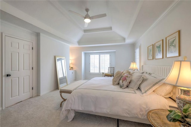 carpeted bedroom with crown molding, a raised ceiling, and ceiling fan