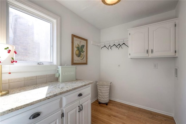 bathroom featuring vanity, wood finished floors, and baseboards