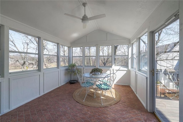 sunroom / solarium featuring a wealth of natural light, a ceiling fan, and vaulted ceiling