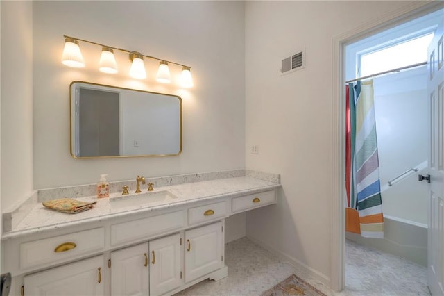 bathroom with visible vents, baseboards, and vanity