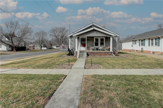 view of front of house with a porch and a front lawn