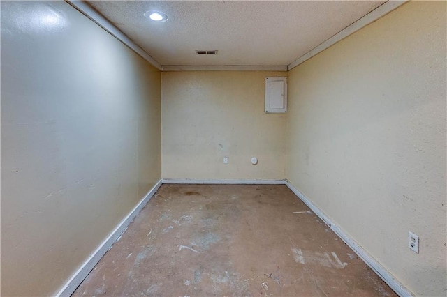 empty room featuring baseboards, visible vents, and a textured ceiling