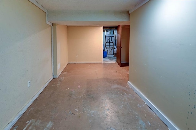 unfurnished room featuring baseboards and concrete floors