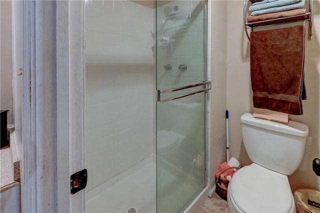 full bath with a stall shower and toilet