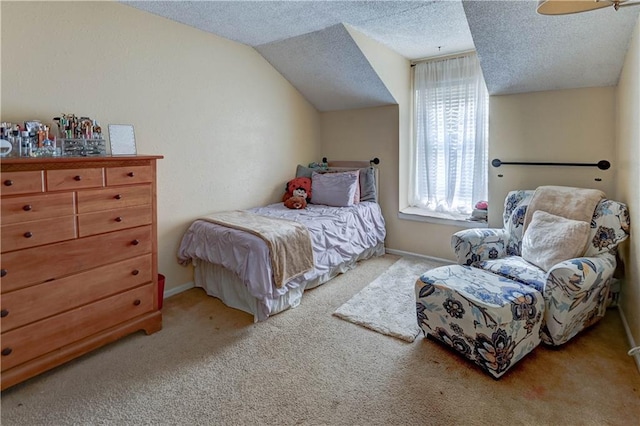 bedroom with baseboards, a textured ceiling, carpet, and vaulted ceiling