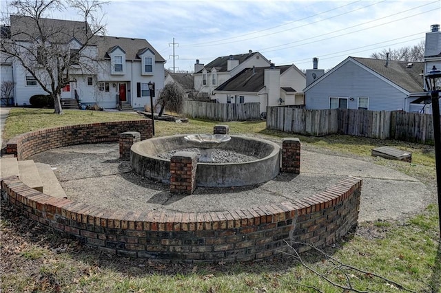 view of yard featuring fence and a residential view