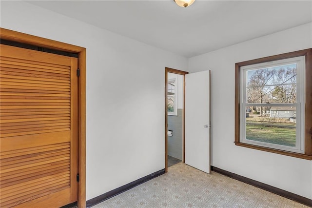 unfurnished bedroom featuring baseboards and light floors