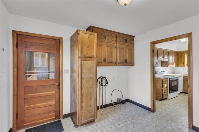 laundry room with light floors and baseboards