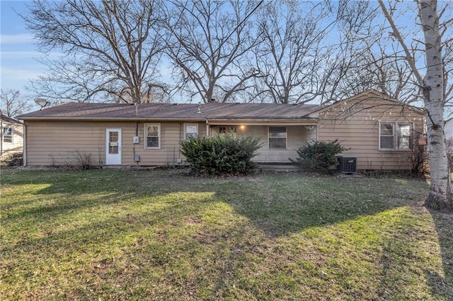 back of house featuring a lawn and central AC unit