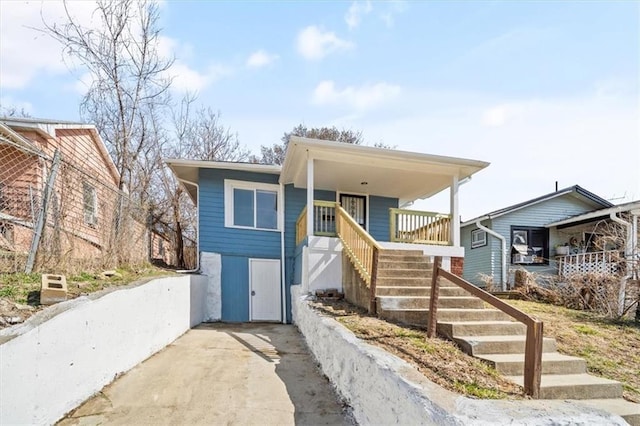 view of front of house with stairway and covered porch